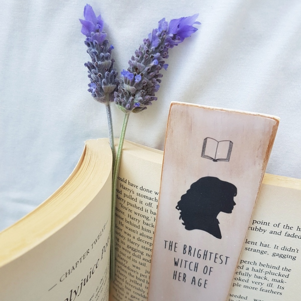 Lavender sprigs and a wooden bookmark in the middle of a book