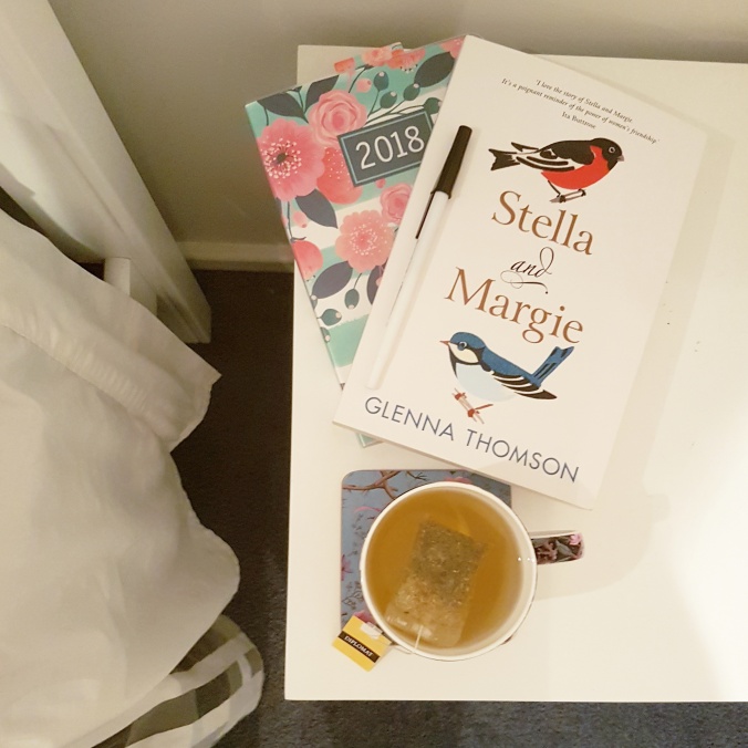 Stella and Margie on a bedside table beside a cup of tea